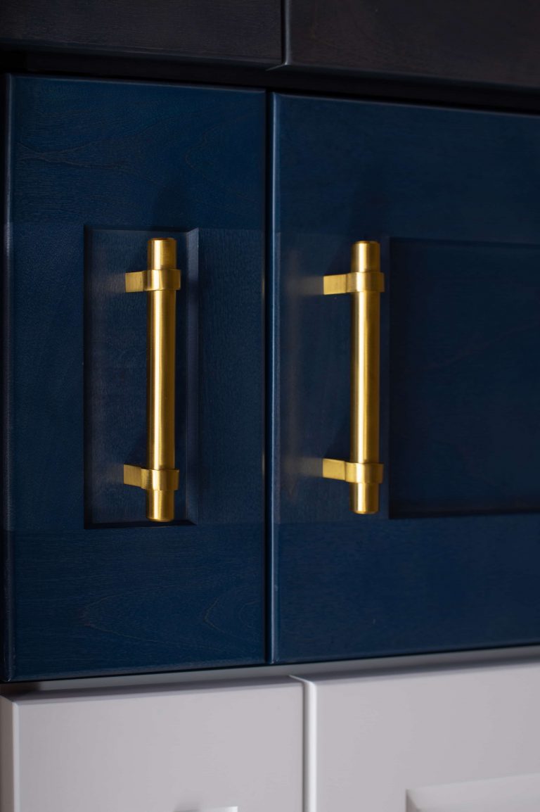 blue cabinet doors with gold bar handles